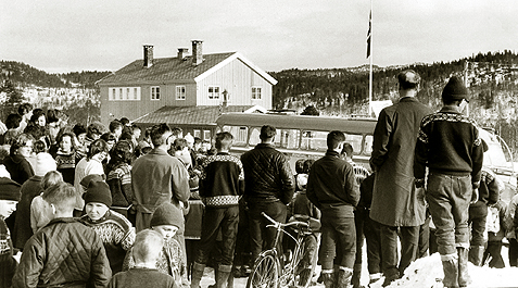 Markering ved Lomundsj&oslash; skule. Rindal Kommunale Auto er p&aring; plass med elever og l&aelig;rere fra Rindal skule. Fremste rekke; Birger Bakken, xxx, Terje xxxx, xxx og Knut B&oslash;rseth (?). Neste rekke, med ryggen til: Per Lj&oslash;kjell, Magne Olav Romundstad, Odd Jostein S&aelig;ter, Asbj&oslash;rn Fl&oslash; og Asbj&oslash;rn B&oslash;rset. Midt inne i flokken, med ansiktet mot kamera, ser vi en av Helgetun-trillingene.